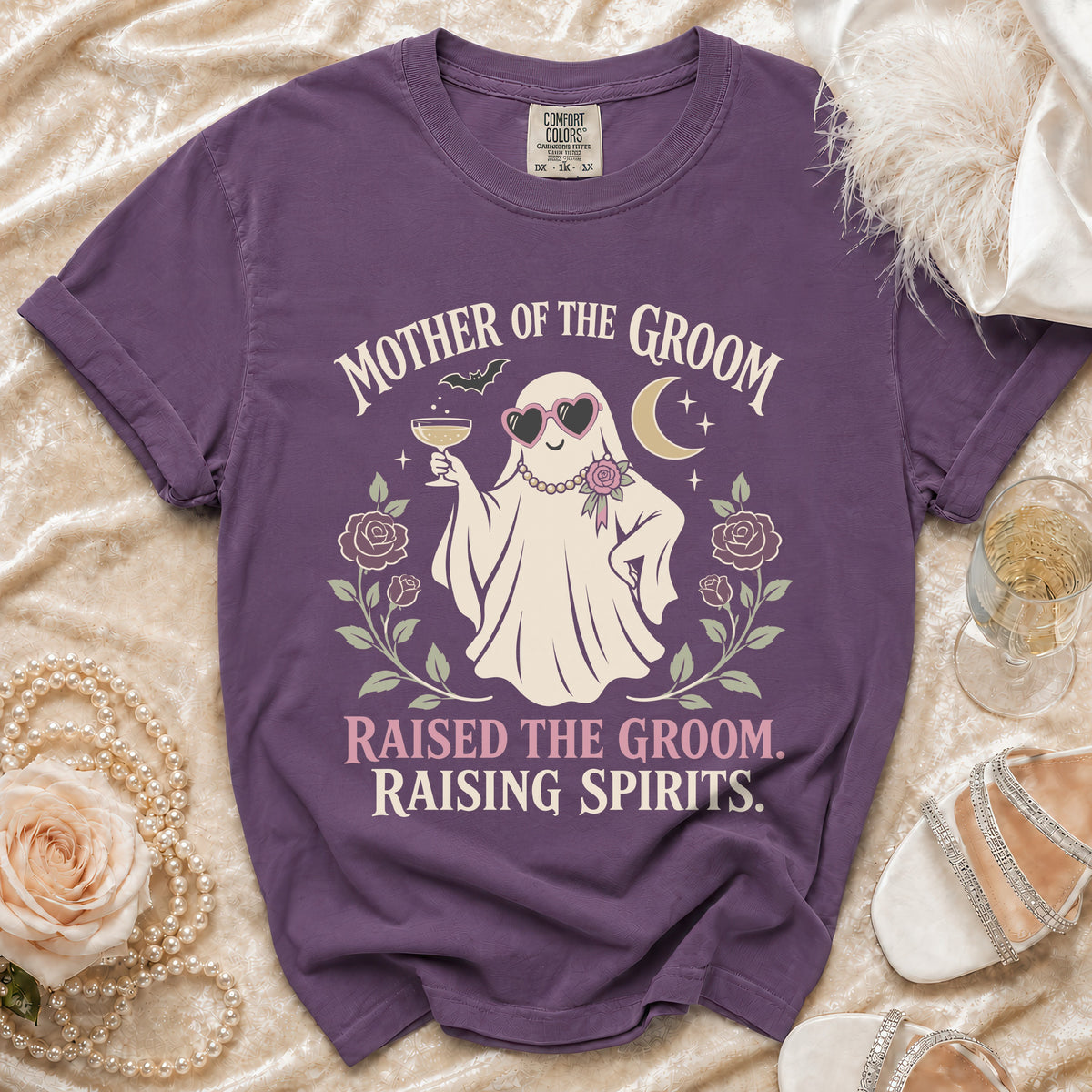 Purple t-shirt with ghost graphic: "Mother of the Groom" and "Raised the groom. Raising spirits."