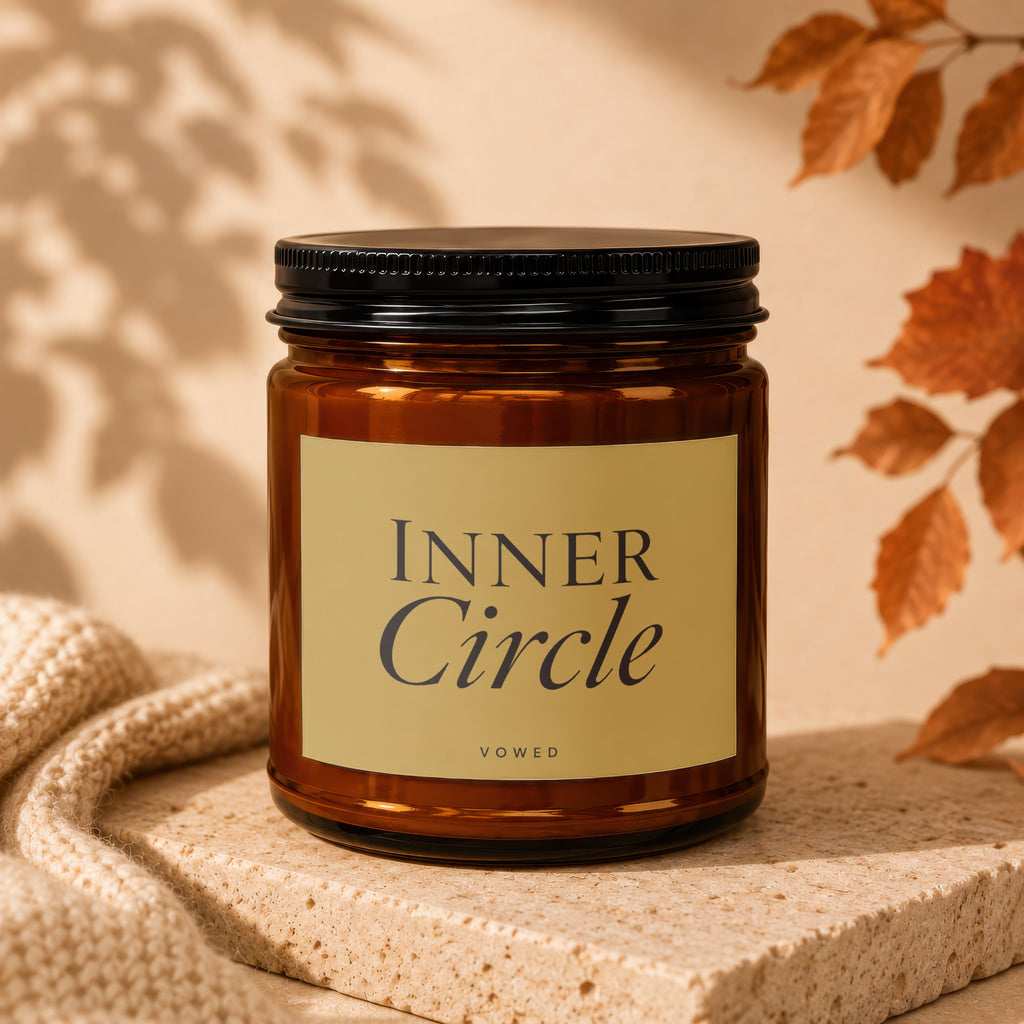 Amber glass candle with black lid and "INNER Circle VOWED" label.