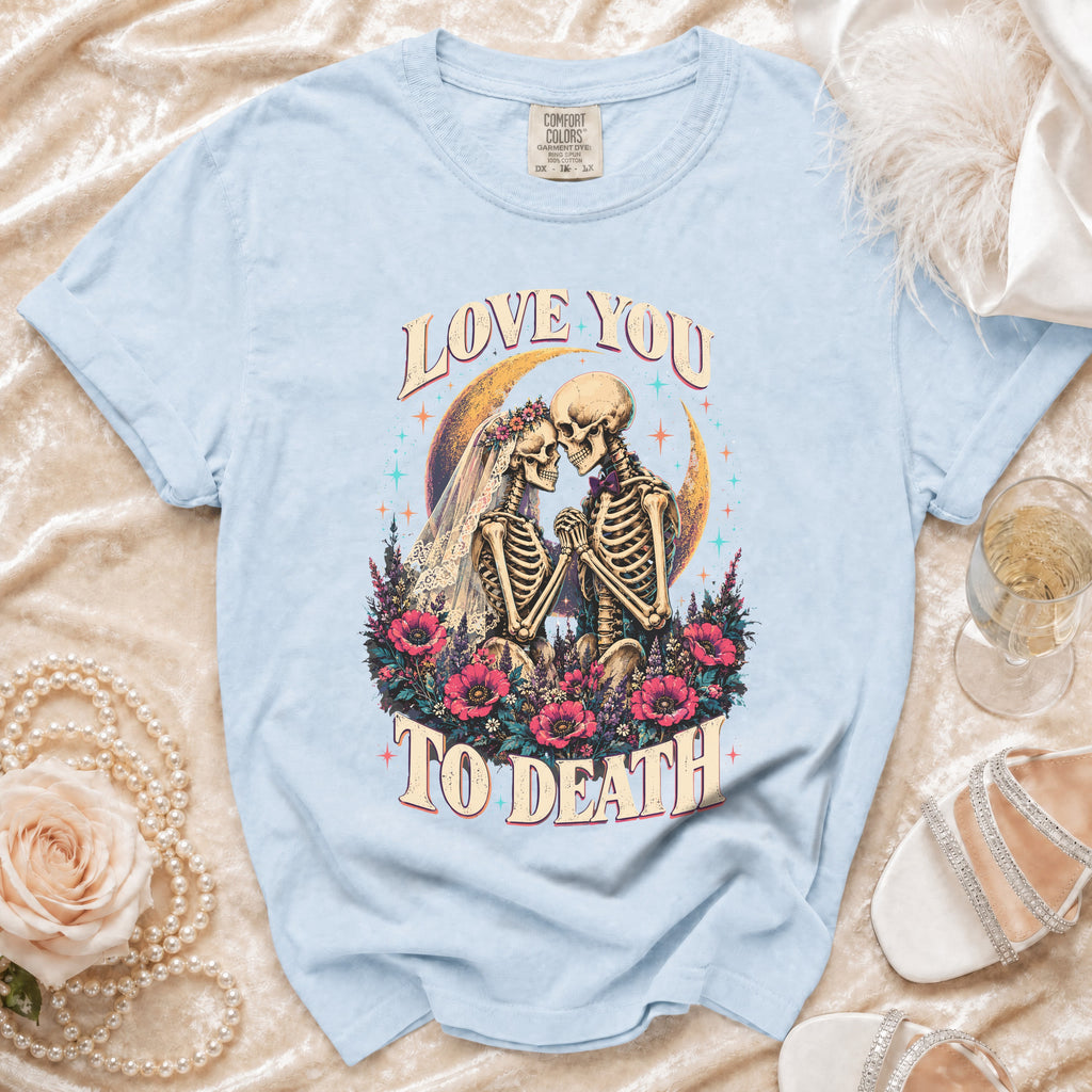 Light blue t-shirt with a skeleton couple in wedding attire and the text "Love You To Death".