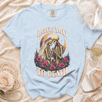 Light blue t-shirt with a skeleton couple in wedding attire and the text "Love You To Death".
