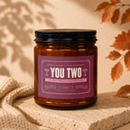Amber candle with "You Two" and engagement message on label.