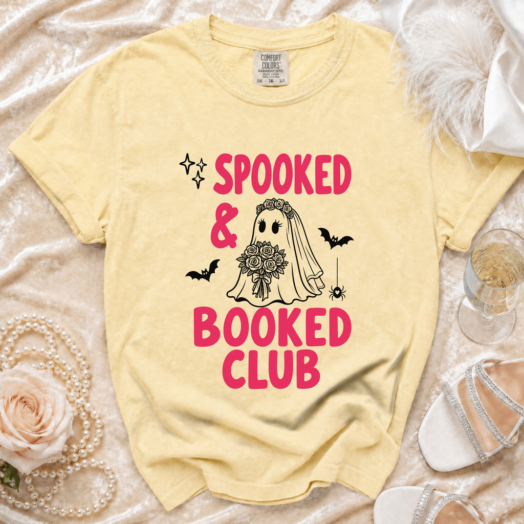 Yellow t-shirt with "Spooked & Booked Club" text, ghost bride, bats, and spider.