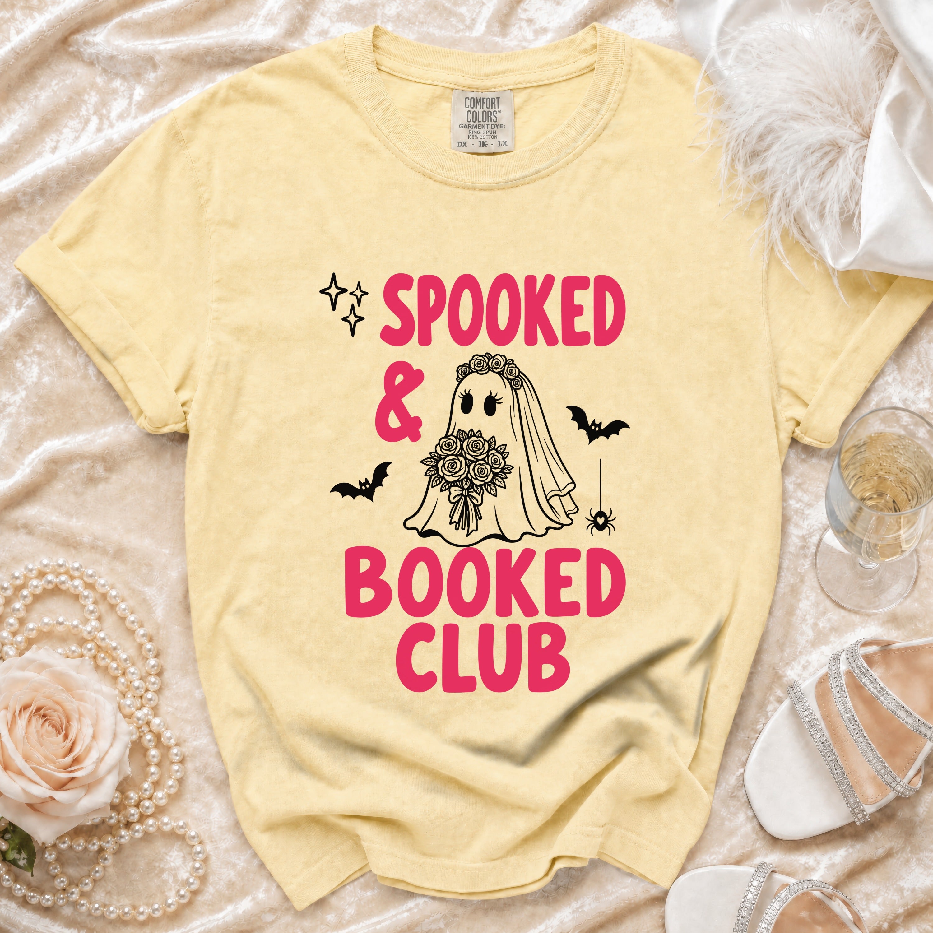 Yellow t-shirt with "Spooked & Booked Club" text, ghost bride, bats, and spider.