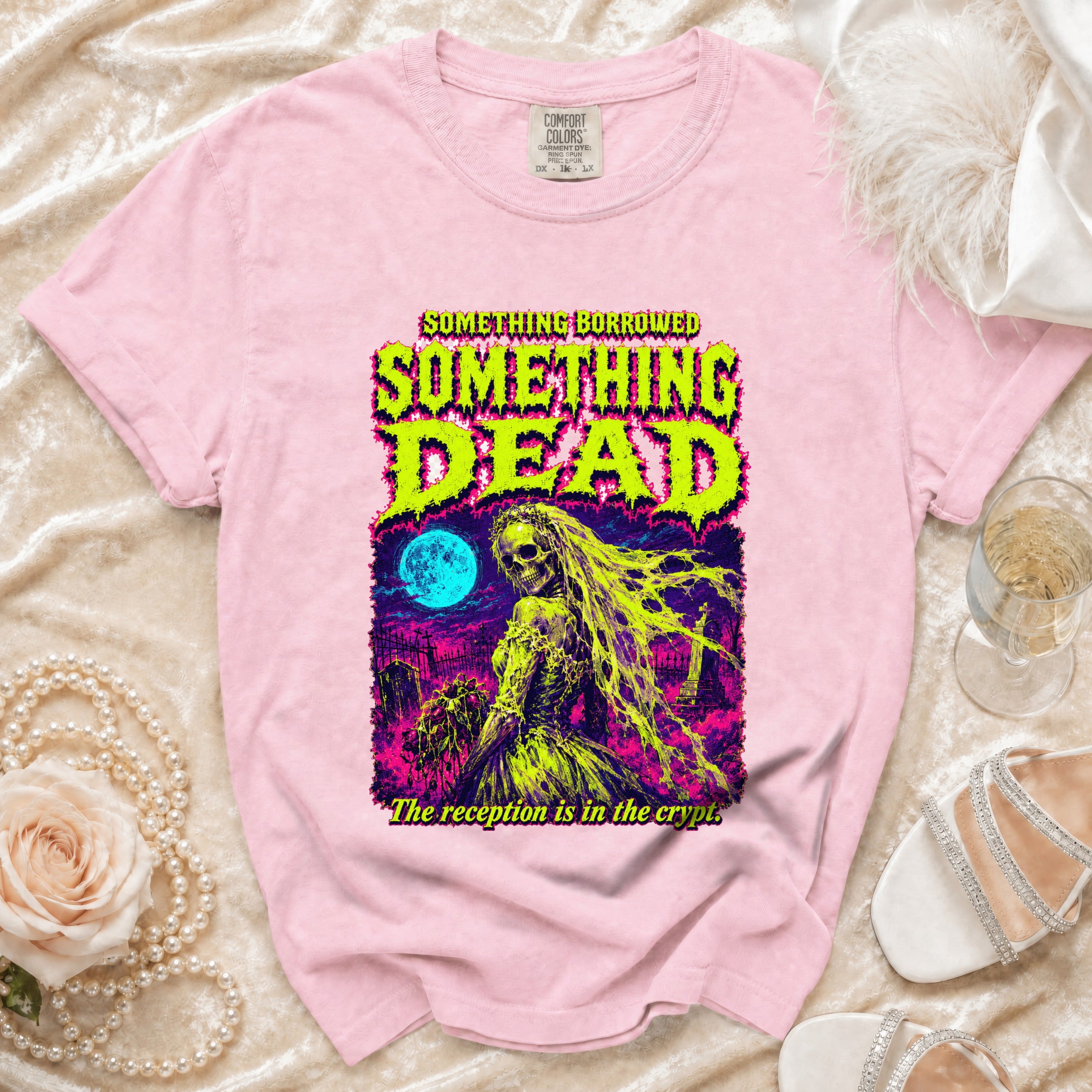 Pink t-shirt with "SOMETHING BORROWED SOMETHING DEAD" graphic and skeleton bride.