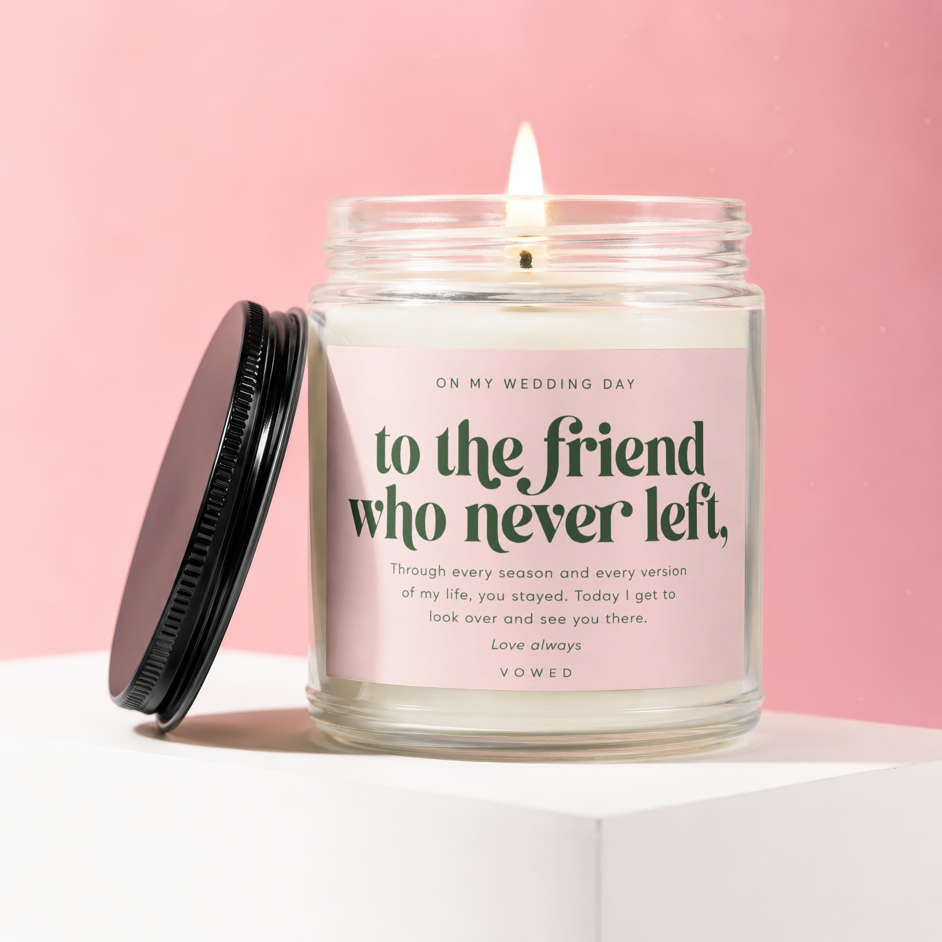 Lit candle with pink label, "to the friend who never left" text.