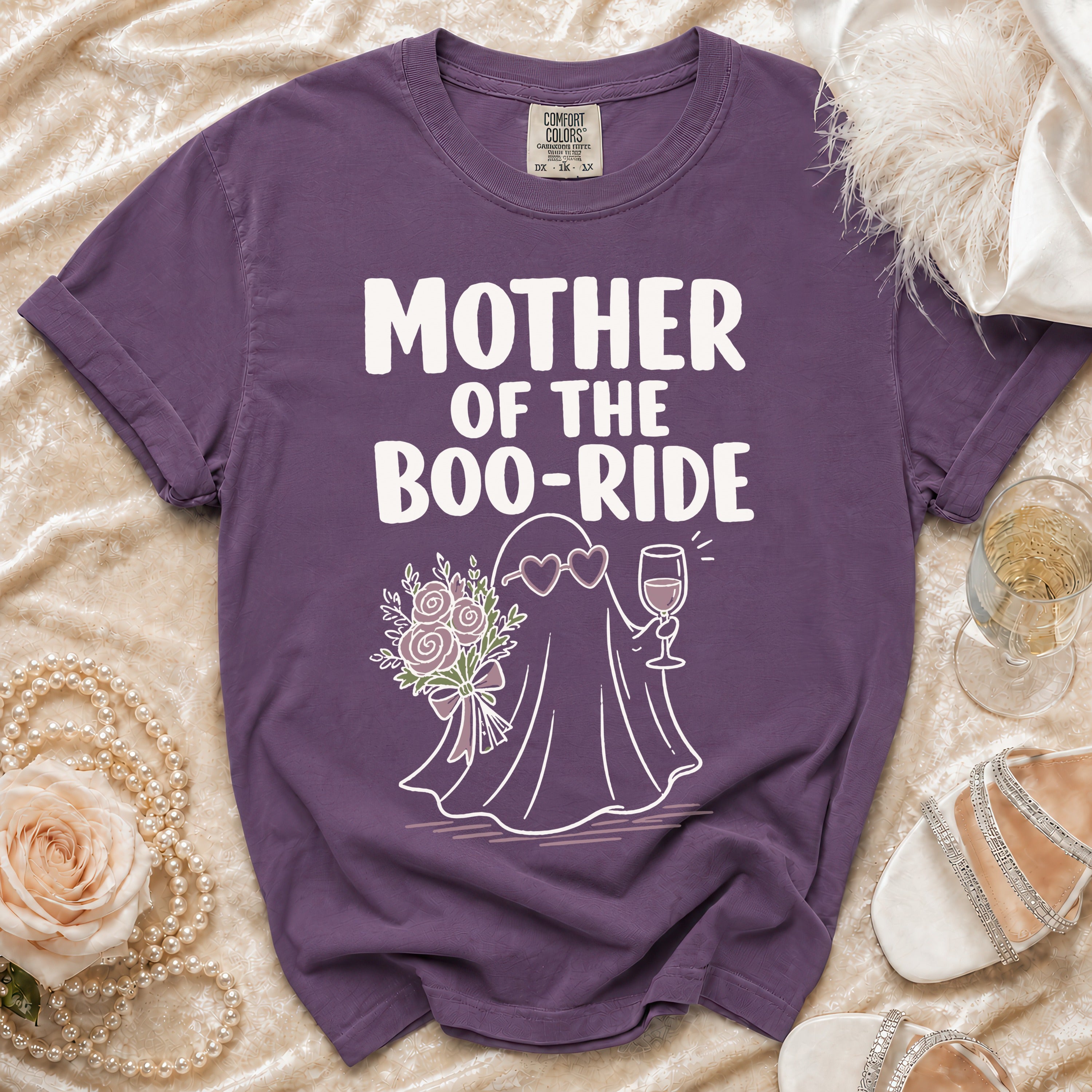 Purple t-shirt with "Mother of the Boo-Ride" text and ghost graphic holding flowers and wine.
