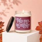 Glass candle on white cube with dark lid, reads "Two mrs, no mister."