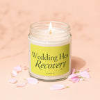 Candle with "Wedding Hex Recovery" and "vowed" text on a yellow label surrounded by petals.