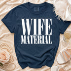 Navy t-shirt with white text "WIFE MATERIAL" and "COMFORT COLORS" label.