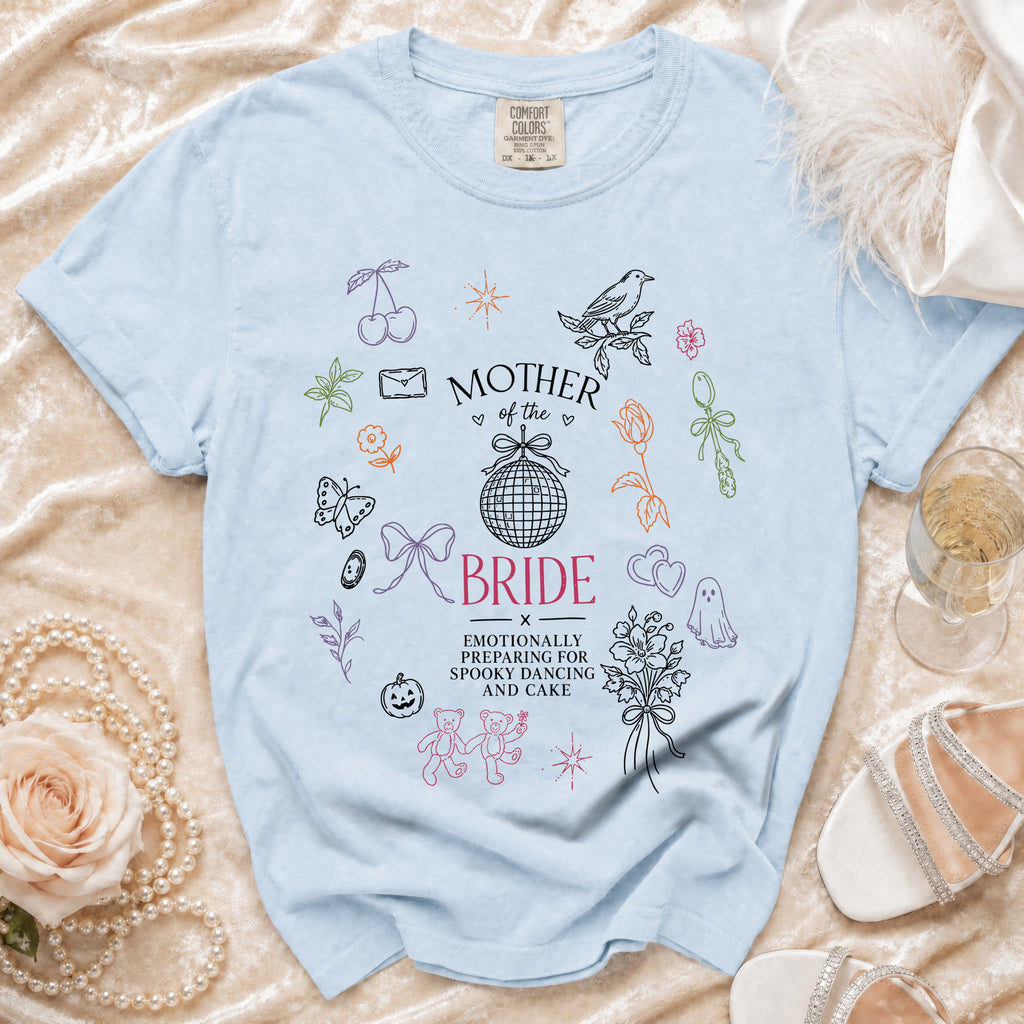 Light blue t-shirt with "Mother of the Bride Emotionally Preparing for Spooky Dancing and Cake" graphic.
