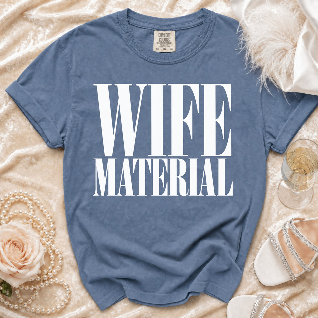 Blue t-shirt with "WIFE MATERIAL" in white block letters.