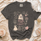 Dark grey t-shirt with bride-themed cartoon graphics and text "Bride to be (Beware)".