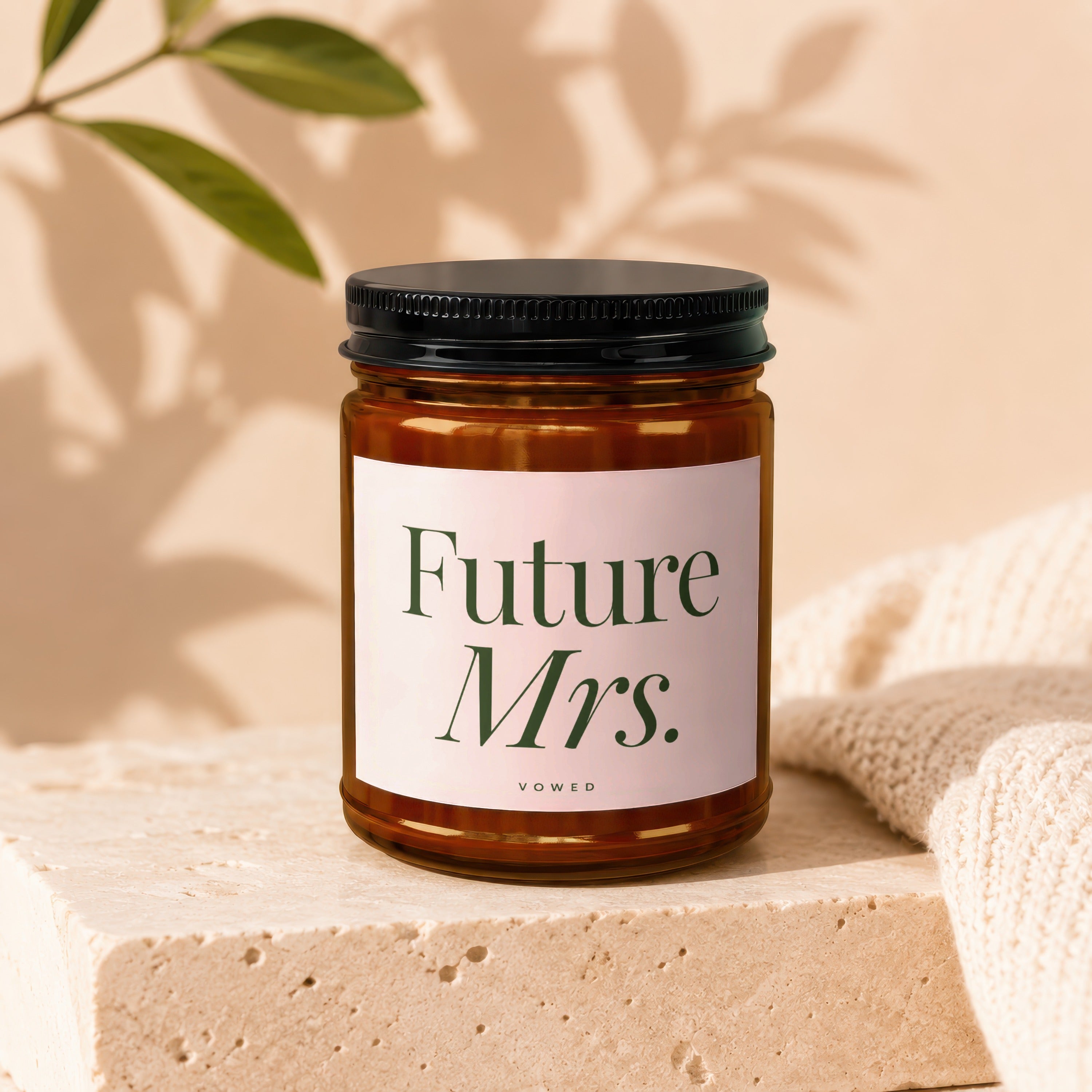 Amber glass candle with "Future Mrs. Vowed" text on a light pink label.