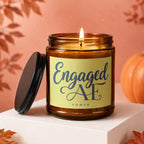 Amber glass candle with "Engaged AF VOWED" text on a light yellow label.