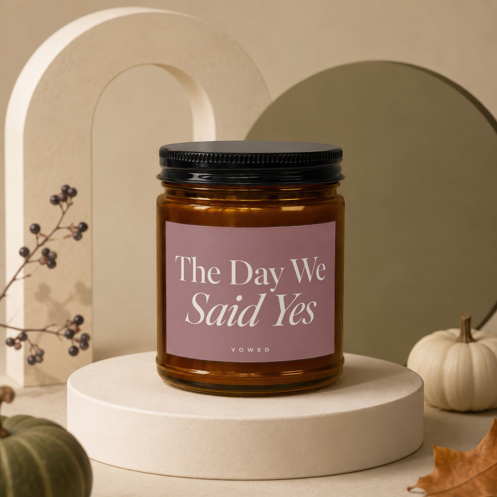 Amber candle with a pink label reading "The Day We Said Yes."
