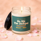 Lit candle with "He Hit The Jackpot Harper + Miles" text on a green label.
