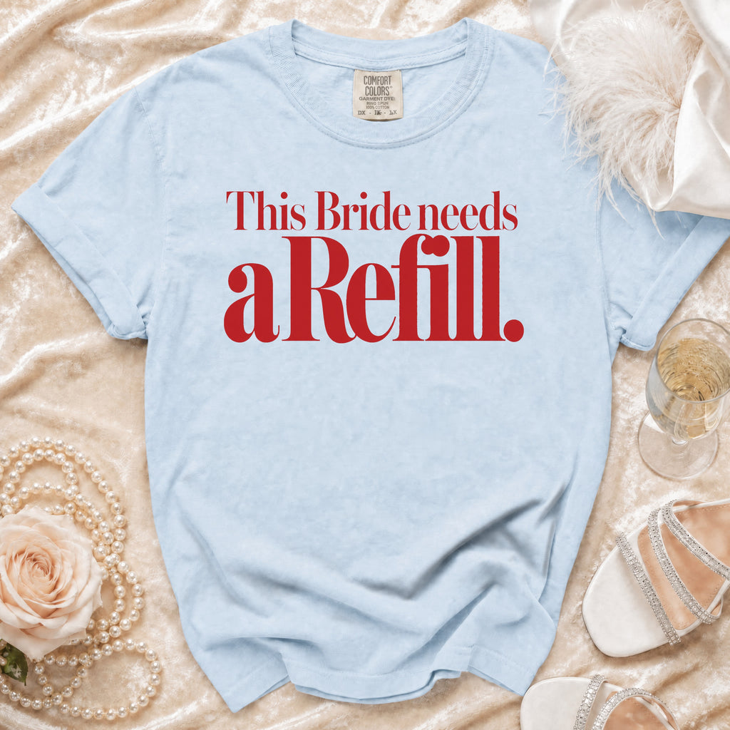 Light blue t-shirt with red text "This Bride needs a Refill."