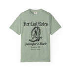 Green t-shirt with "Her Last Rodeo" and cowboy boot graphic.