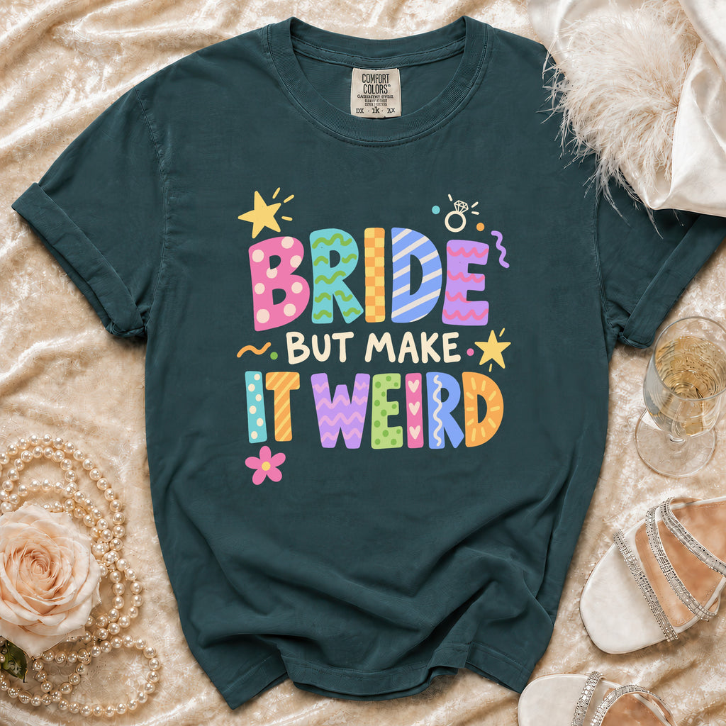 Dark green t-shirt with "BRIDE BUT MAKE IT WEIRD" text in colorful block letters.