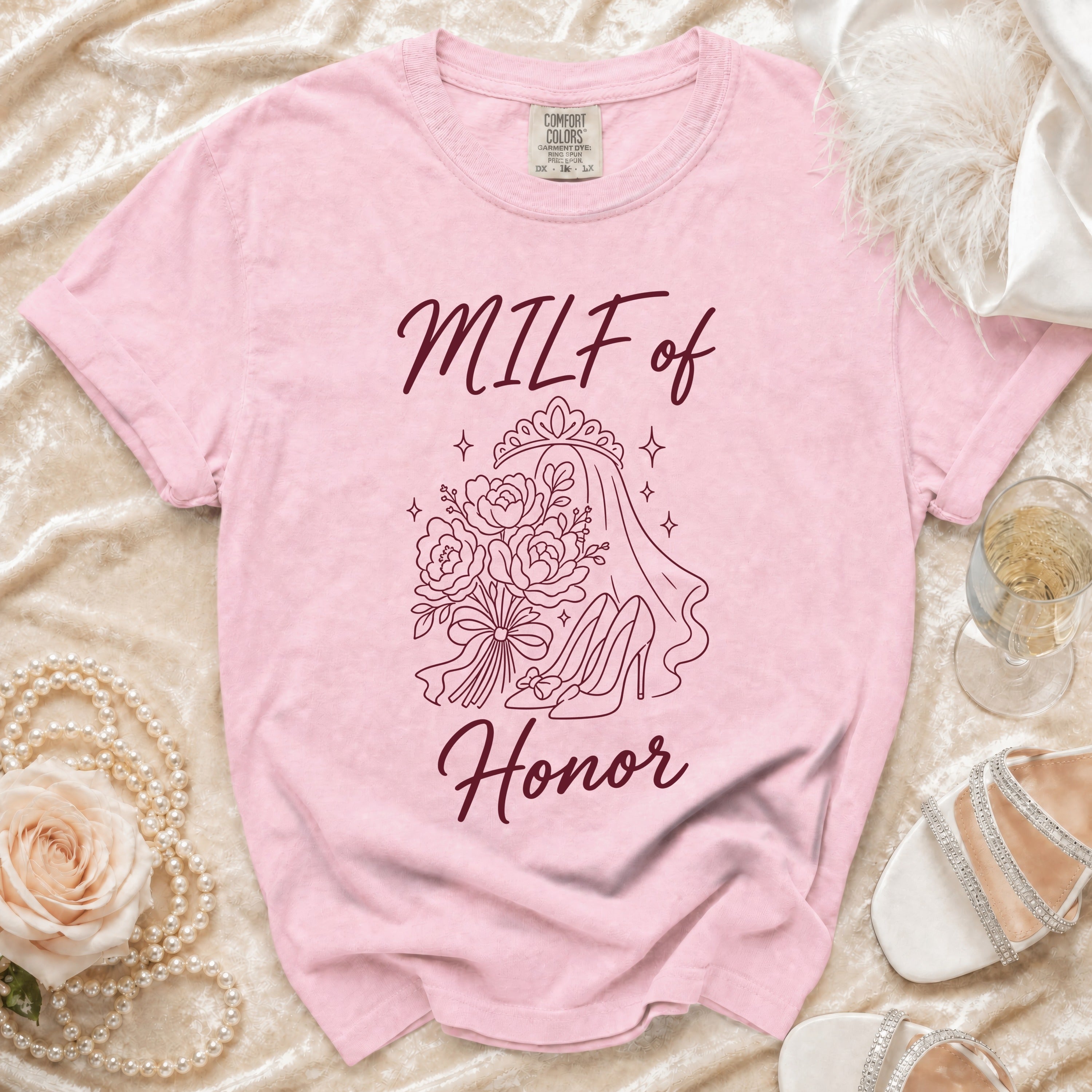 Pink t-shirt with "MILF of Honor" printed in burgundy, featuring bridal graphics.