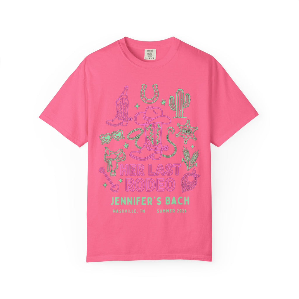 Pink t-shirt with "Her Last Rodeo" graphic in green, cowboy boots, sheriff star, and cactus.
