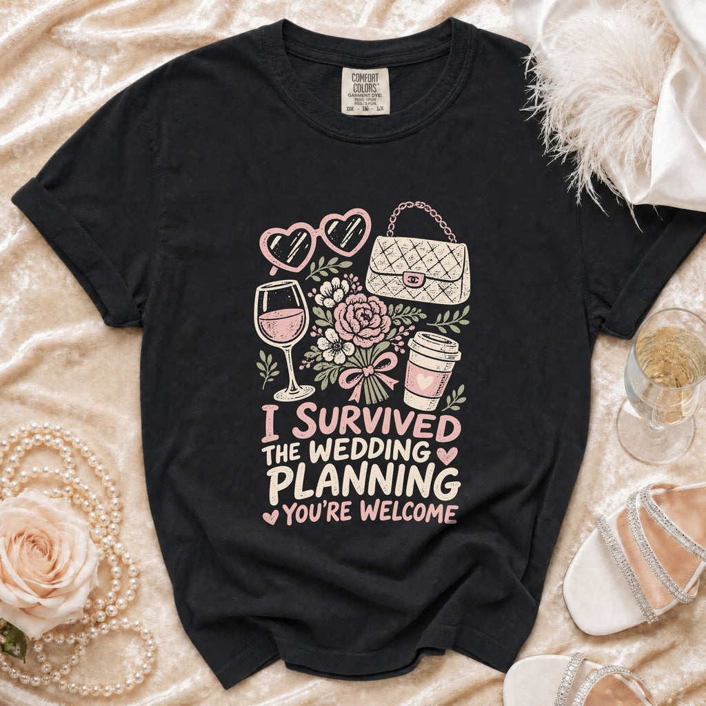 Black t-shirt with "I survived the wedding planning you're welcome" graphic.