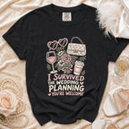 Black t-shirt with "I survived the wedding planning you're welcome" graphic.