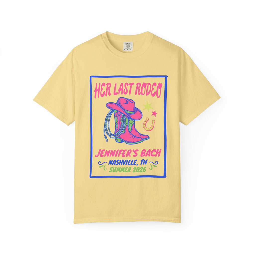Yellow t-shirt with "Her Last Rodeo" graphic, cowboy hat, boots, and horseshoe.