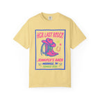 Yellow t-shirt with "Her Last Rodeo" graphic, cowboy hat, boots, and horseshoe.