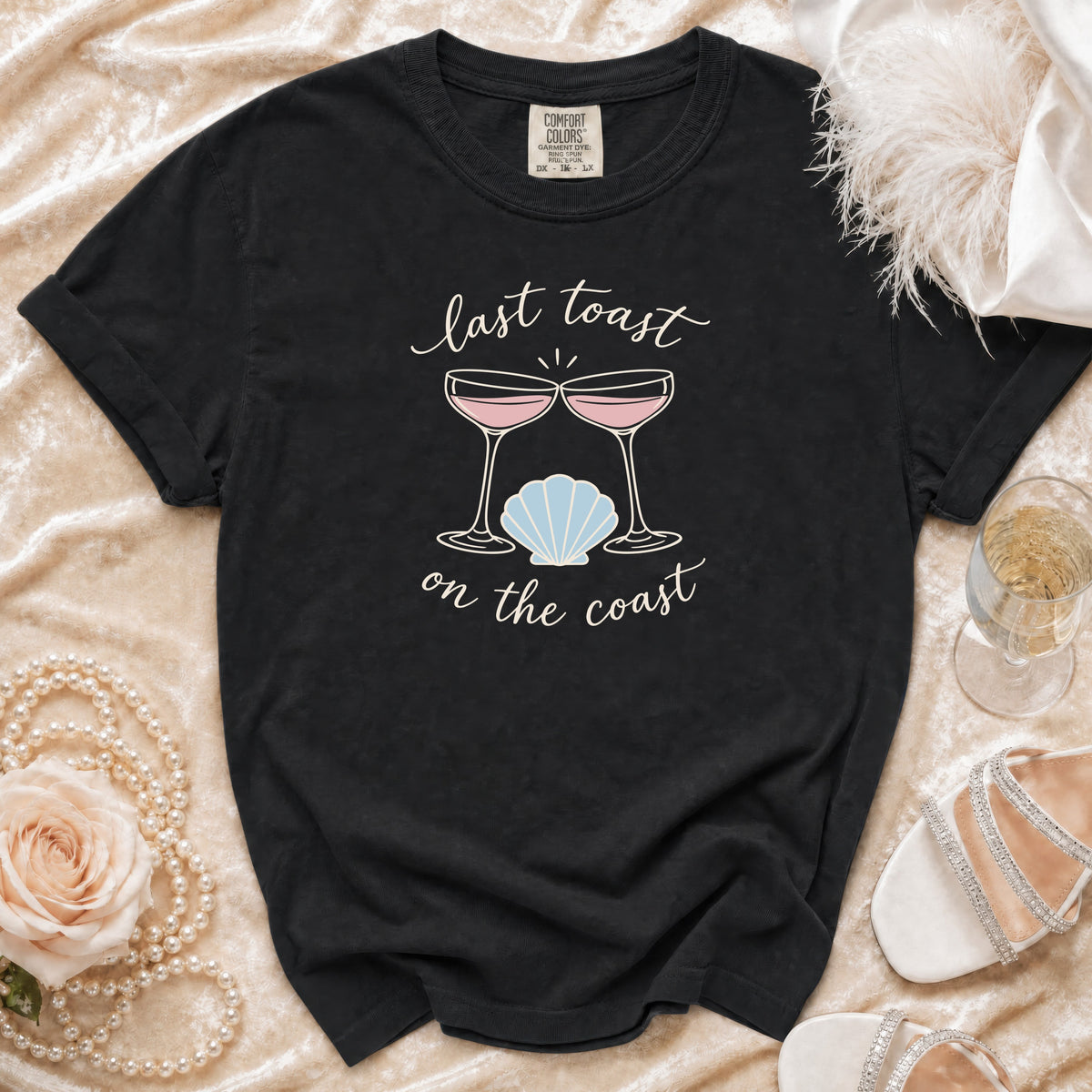 Black Comfort Colors t-shirt with "Last Toast on the Coast" text and champagne glasses graphic.