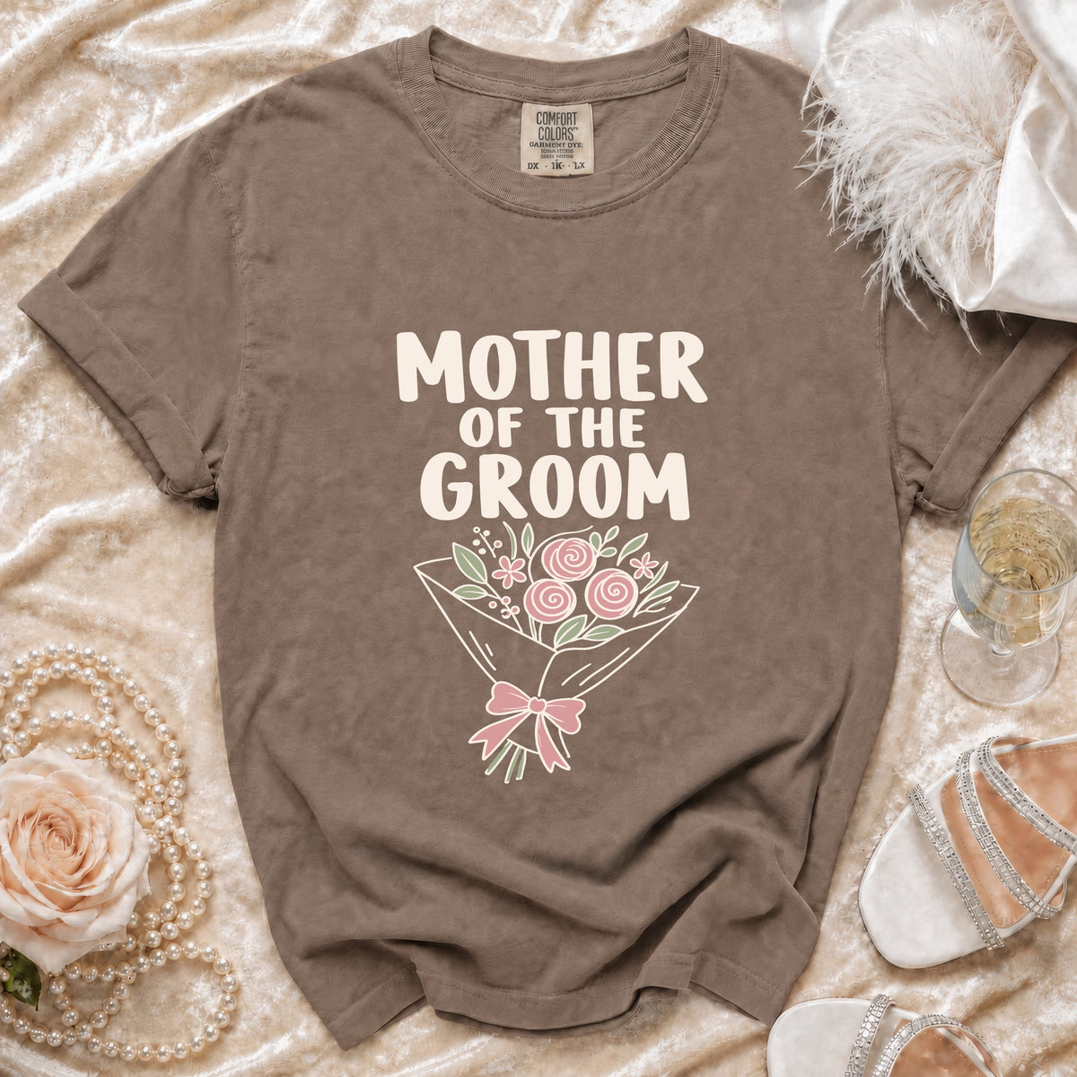 Brown t-shirt with "MOTHER OF THE GROOM" text and floral bouquet graphic.
