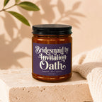 Candle with label reading "Bridesmaid by Invitation Oath".