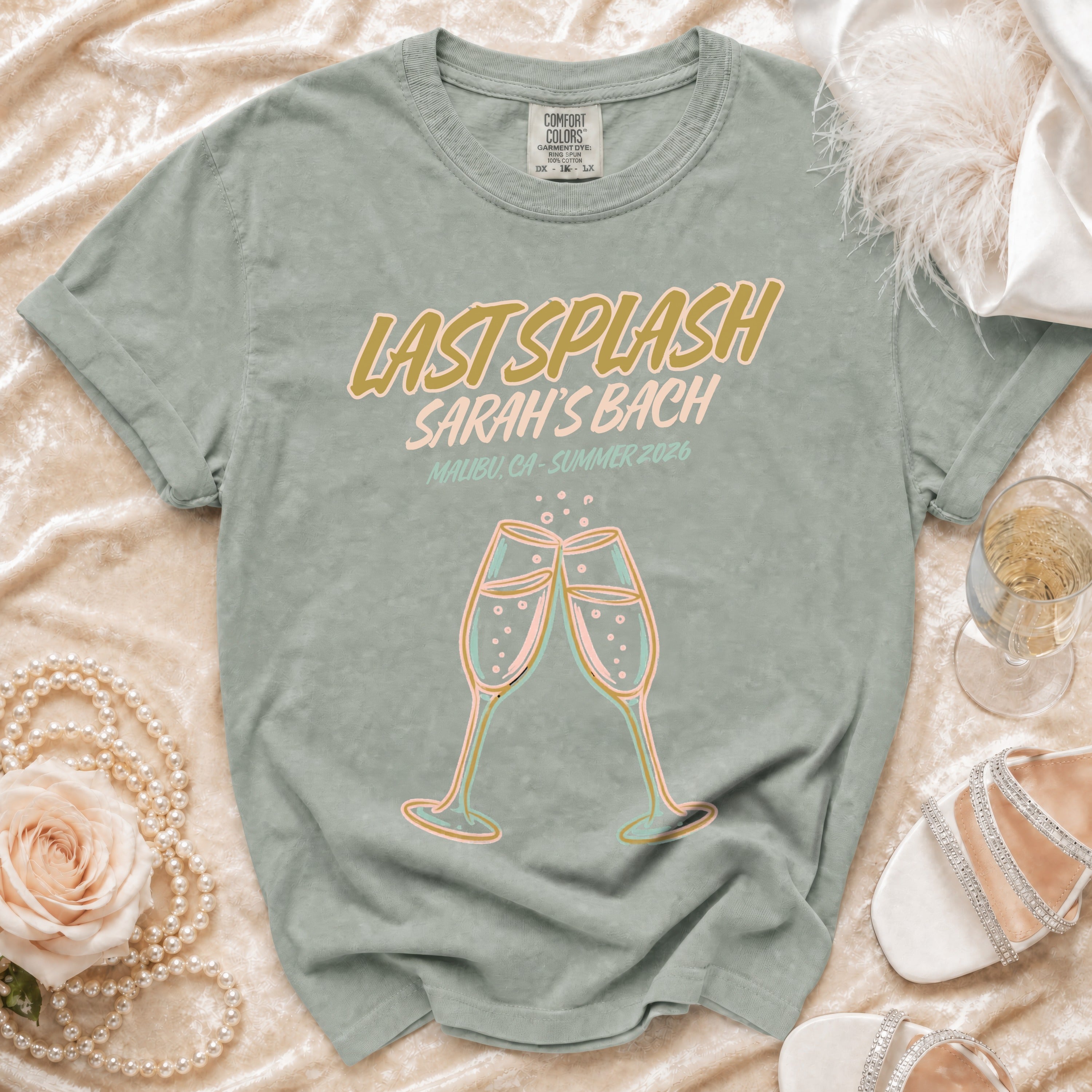 T-shirt with "Last Splash Sarah's Bach Malibu CA Summer 2026" text and champagne glasses.