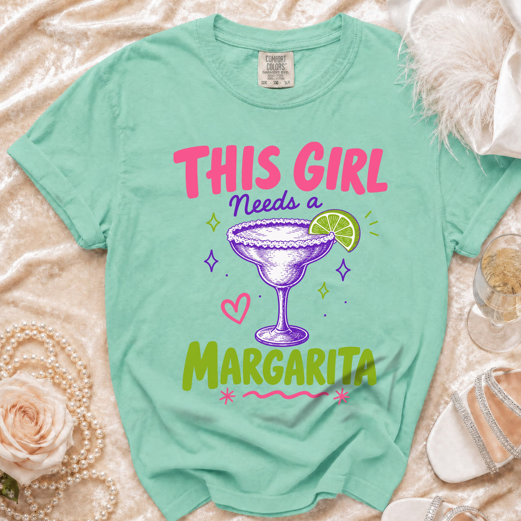 Mint green t-shirt with "This girl needs a margarita" text and graphic.