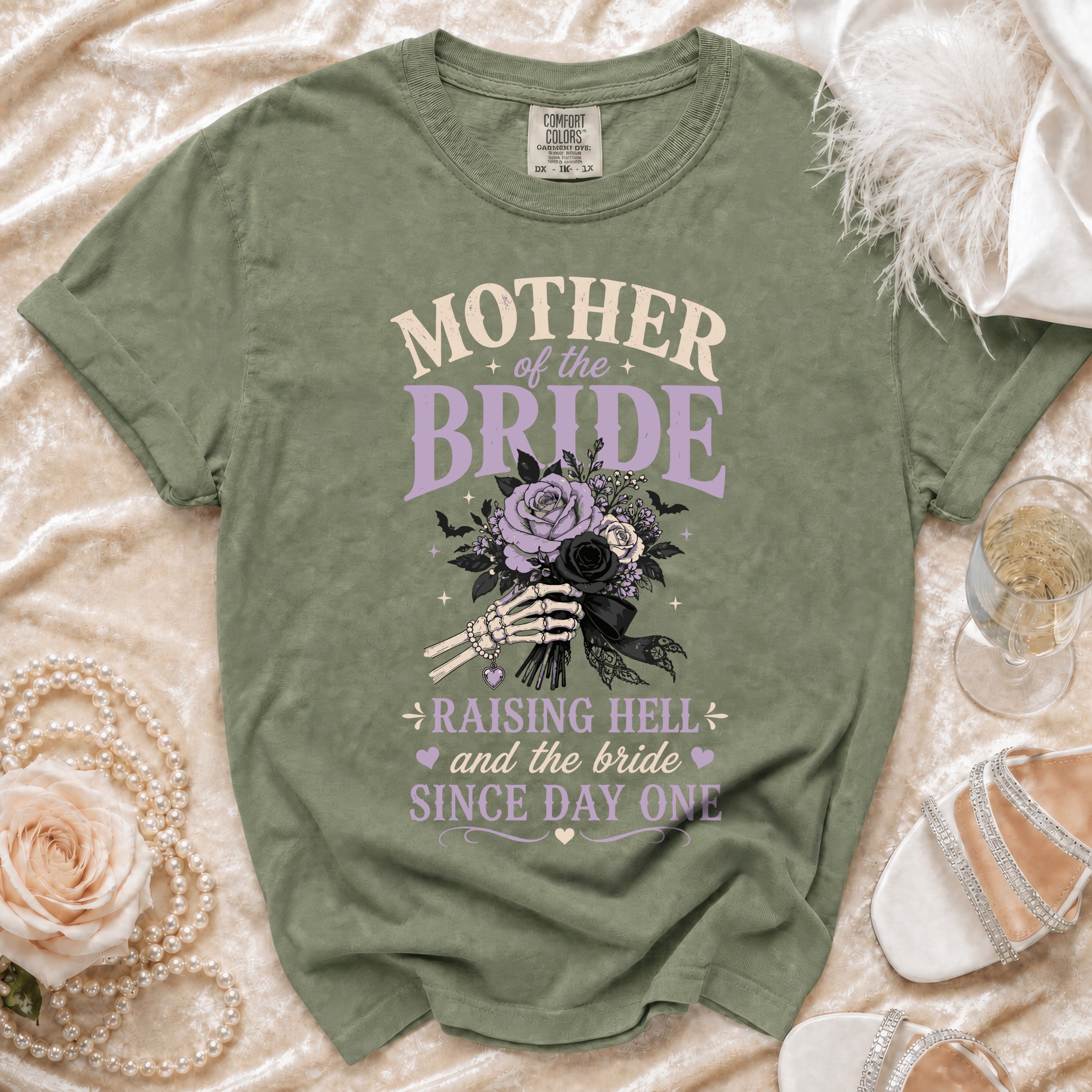 Green t-shirt with "Mother of the Bride Raising Hell" design and skeleton hands holding flowers.
