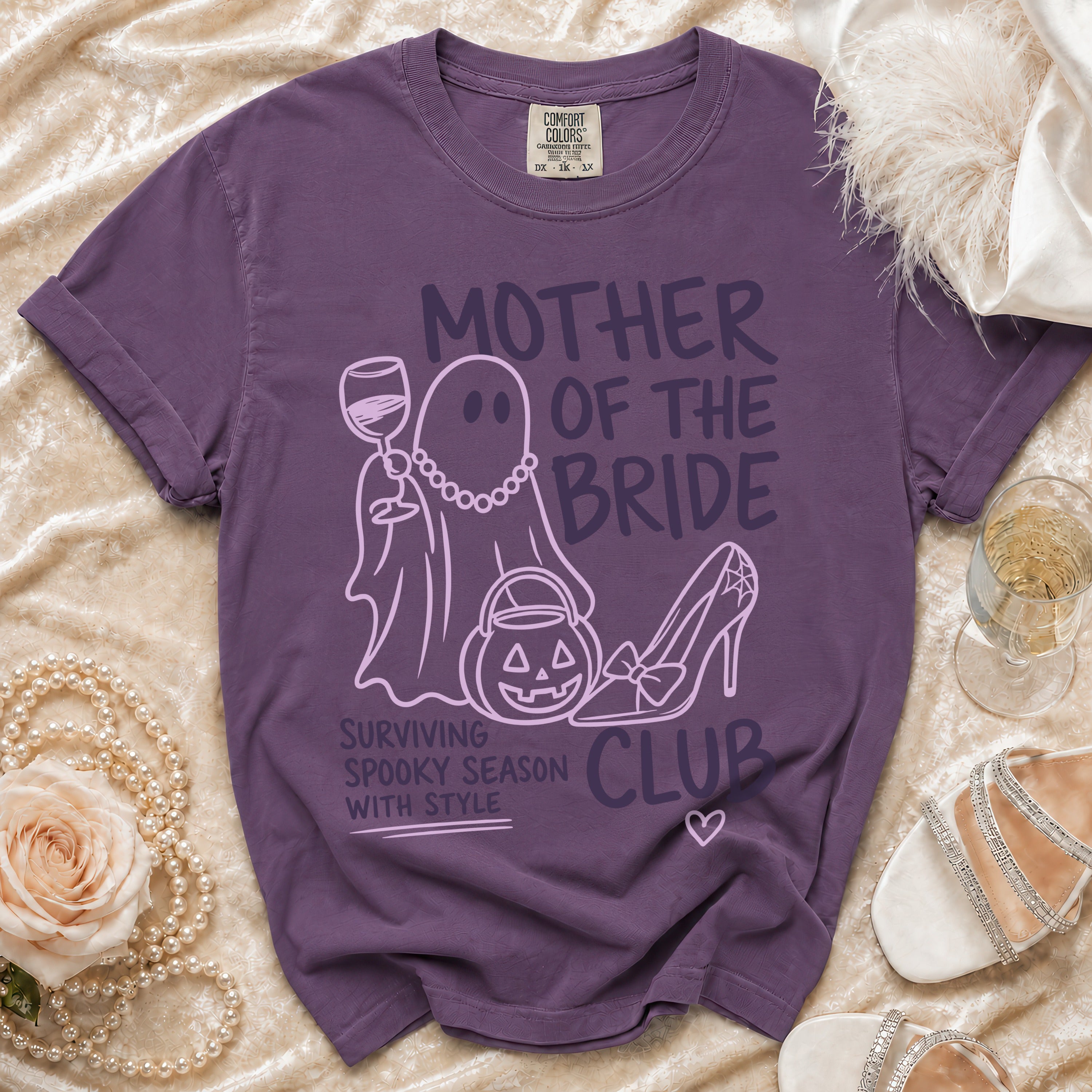 Purple t-shirt with "Mother of the Bride" text, ghost, pumpkin, and high heel graphic.
