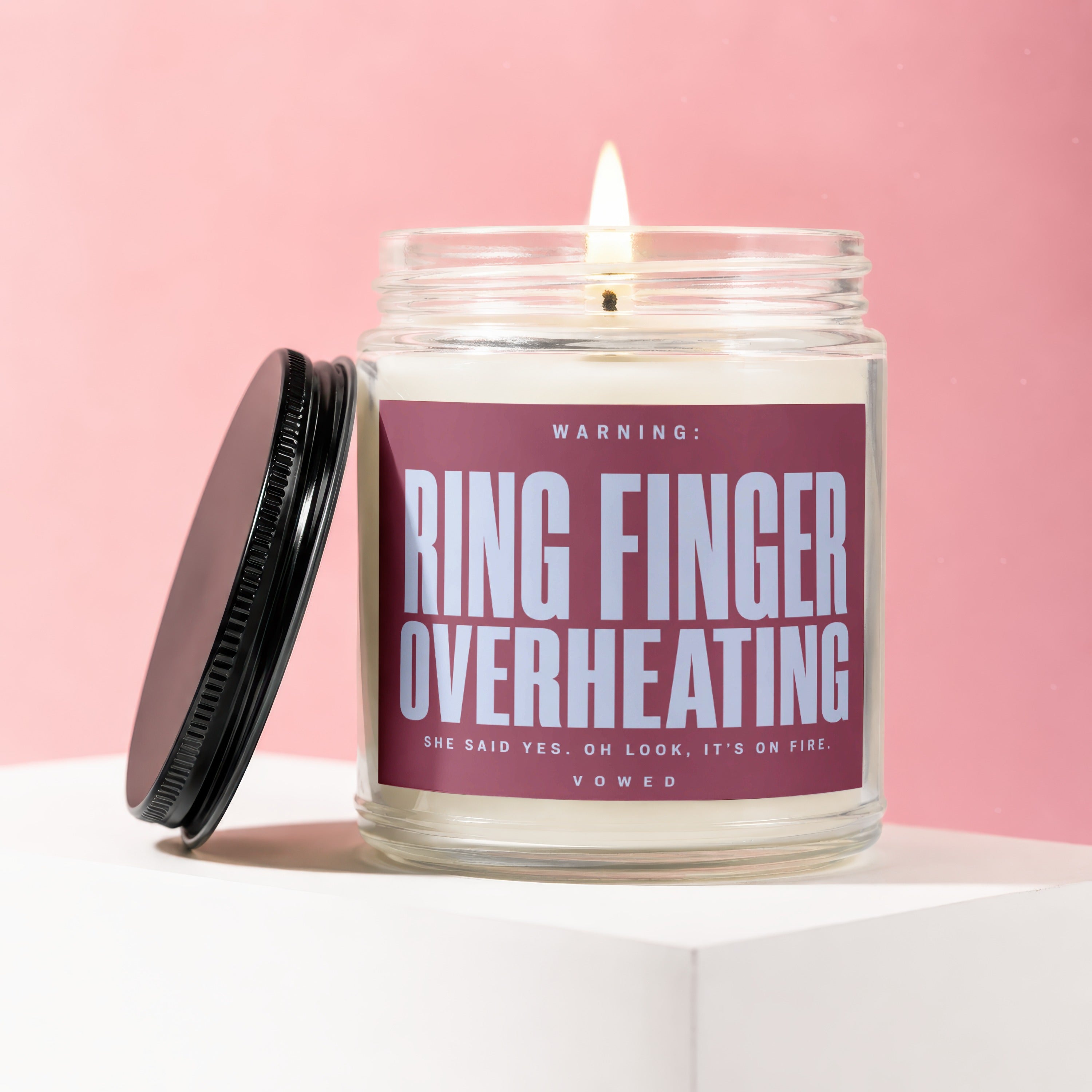 Jar candle with "Ring Finger Overheating" warning and "She Said Yes" text.