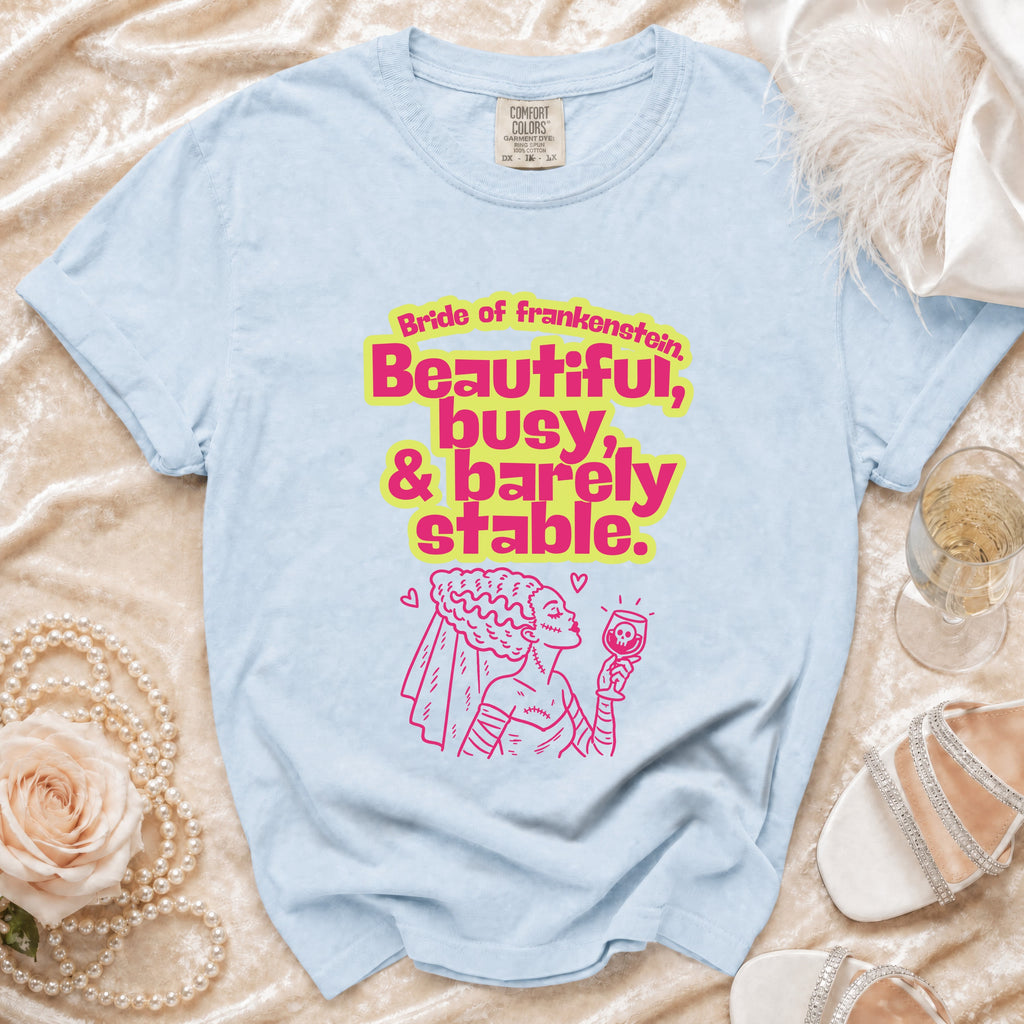 Light blue t-shirt with "Bride of Frankenstein, Beautiful, busy, & barely stable" text and graphic.