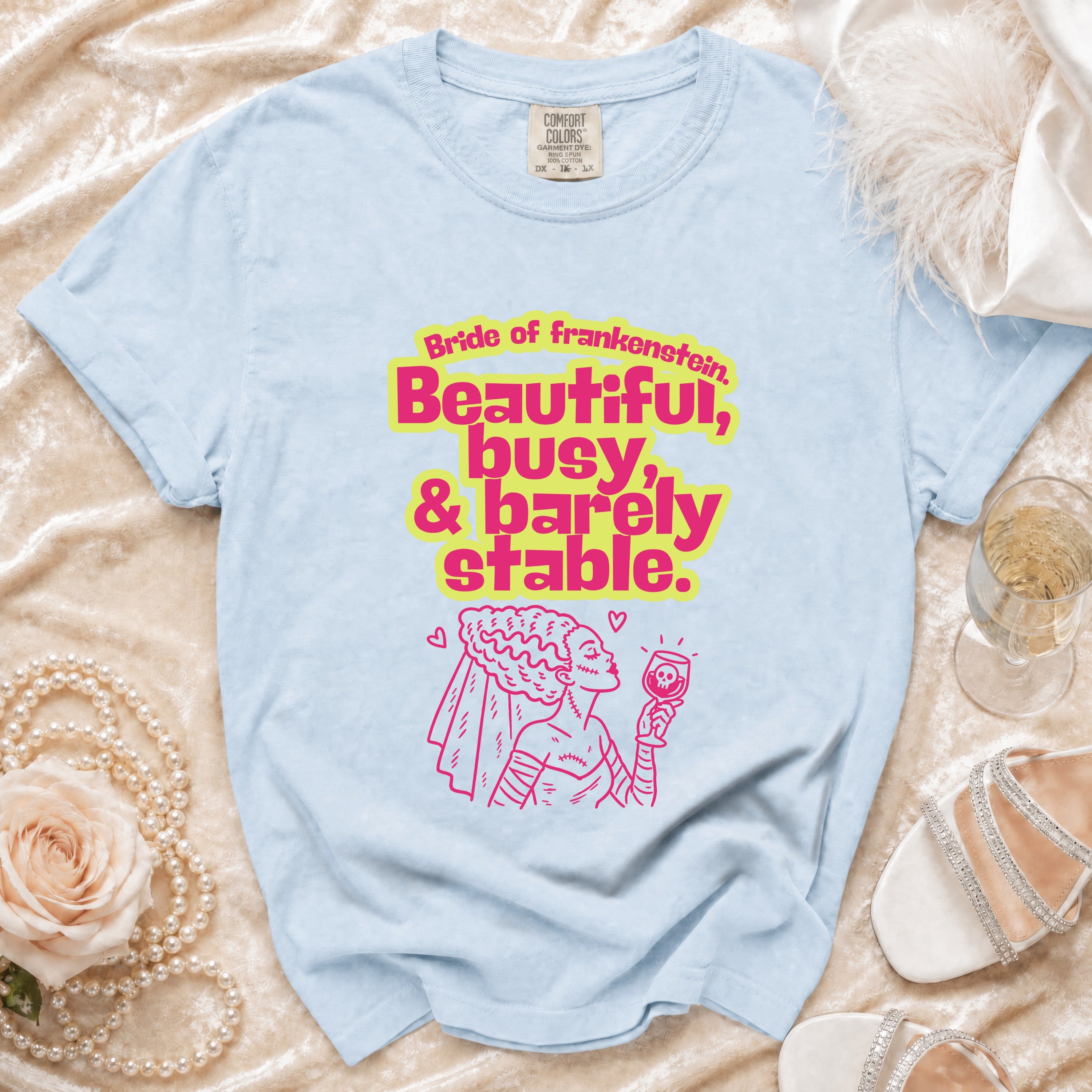 Light blue t-shirt with "Bride of Frankenstein, Beautiful, busy, & barely stable" text and graphic.