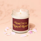 Scented candle with "You're a Man of Honor" text, surrounded by petals.