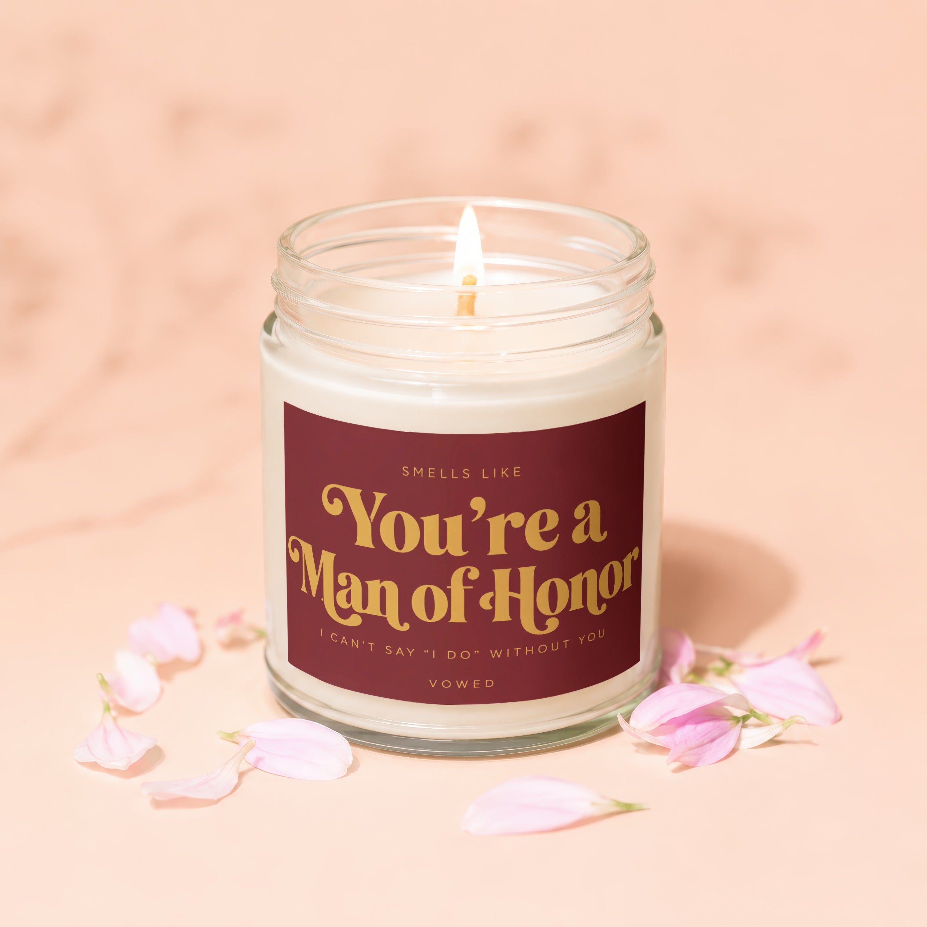 Scented candle with "You're a Man of Honor" text, surrounded by petals.