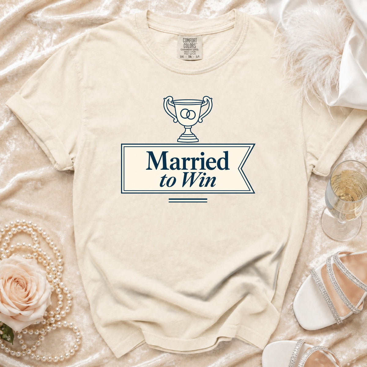 Cream t-shirt with navy graphic "Married to Win" and trophy.