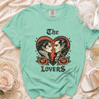 Green t-shirt with vintage vampire couple in heart graphic and "The Lovers" text.
