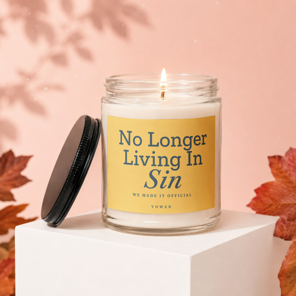 Lit candle with yellow label reading "No Longer Living In Sin" and "VOWED".