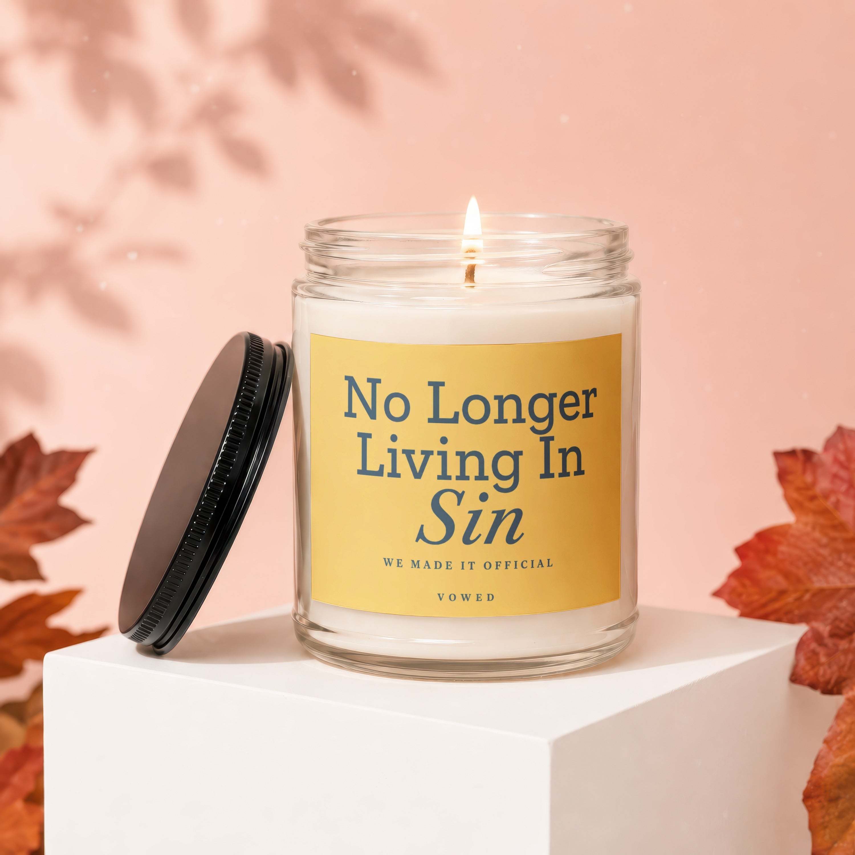 Lit candle with yellow label reading "No Longer Living In Sin" and "VOWED".