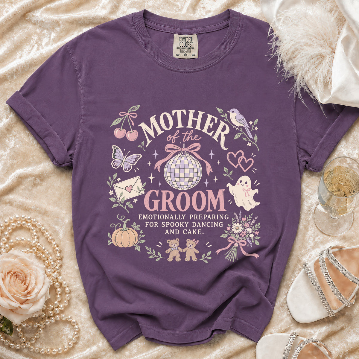 Purple shirt with "Mother of the Groom" and spooky/cute graphics.