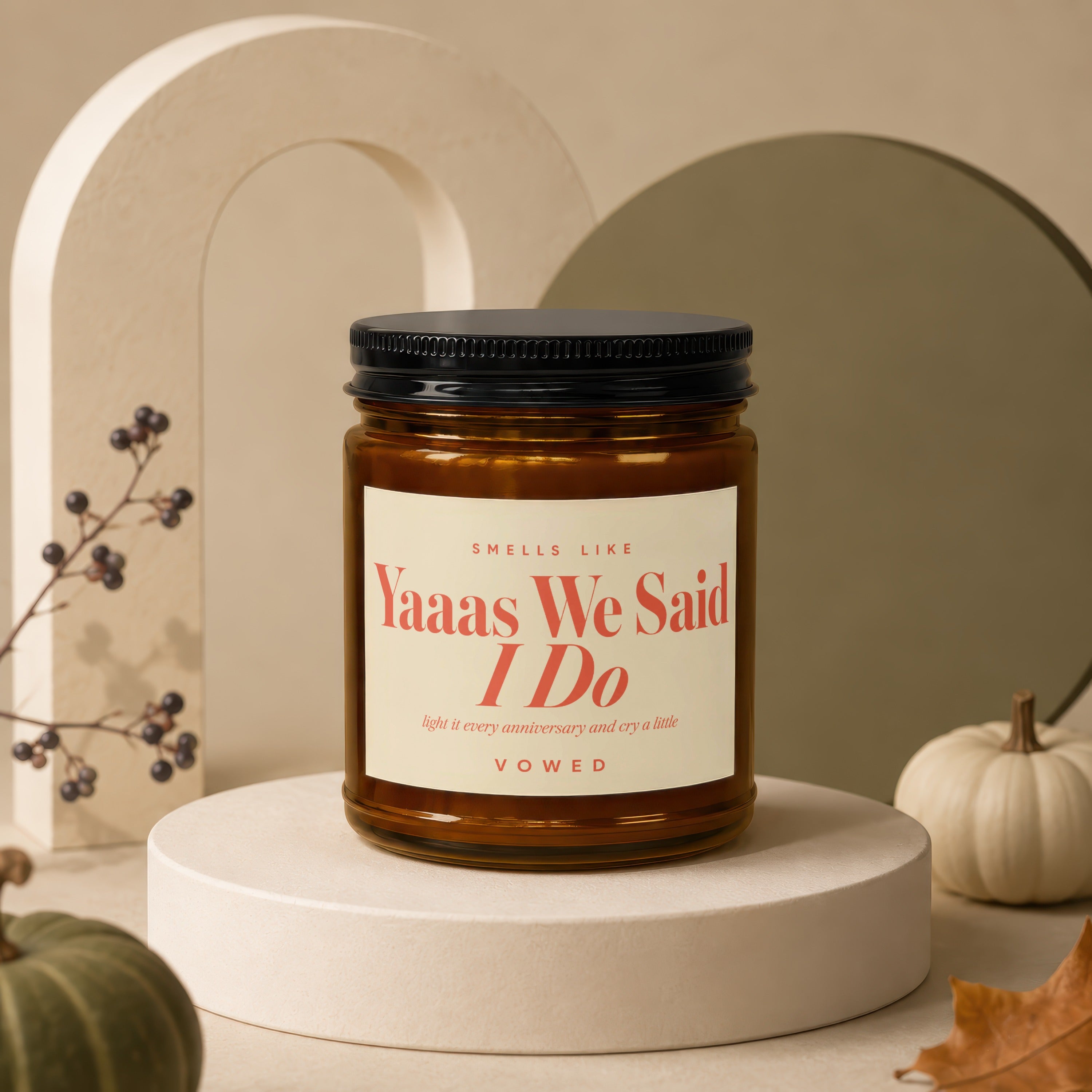 Amber jar candle with "Yaaas We Said I Do" text, "Vowed" inscription.