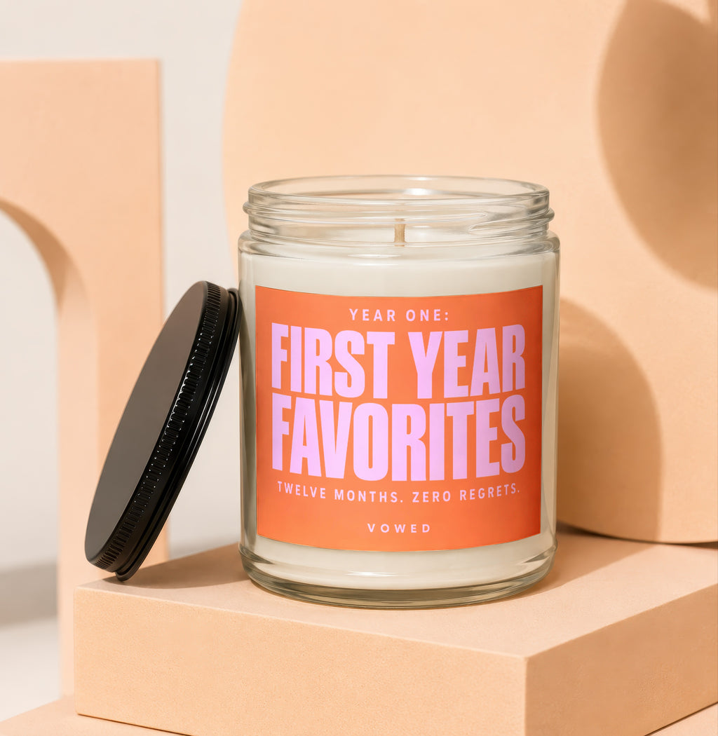 Candle with label that says "Year One: First Year Favorites. Twelve Months. Zero Regrets. Vowed."