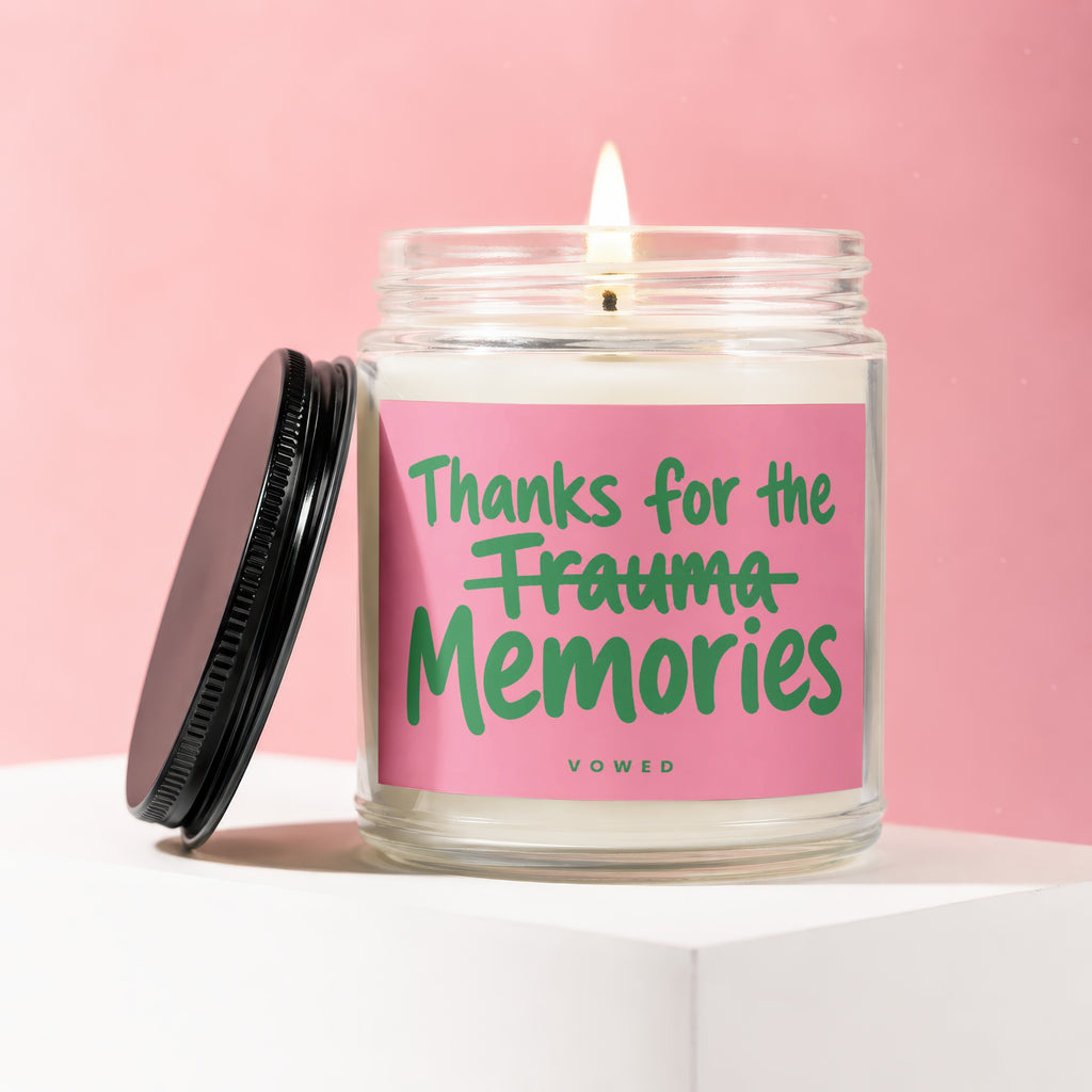 Candle with pink label reading "Thanks for the Trauma Memories"
