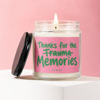 Candle with pink label reading "Thanks for the Trauma Memories"